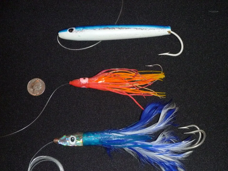 Albacore lures top to bottom:  Cedar plug, rubber squid at the end of a daisy chain, Zukers tuna feather