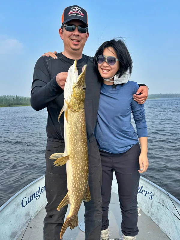 The author and his daughter with a solid Pike caught in Egenolf Lake, Canada