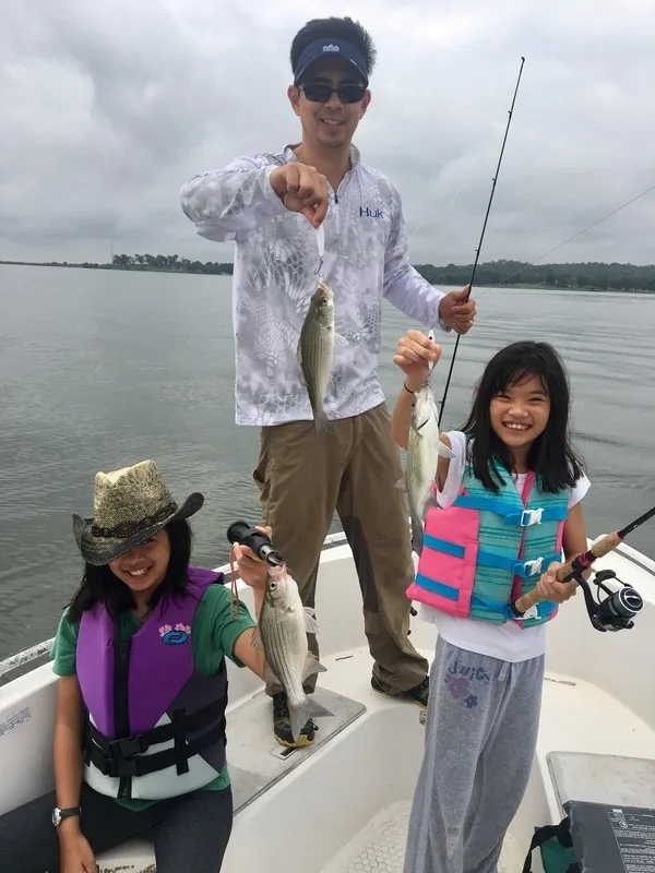 Three casts, and three fish. That's how White Bass fishing can be when you find a feeding school.  Here the author and his daughters show some average-sized White Bass