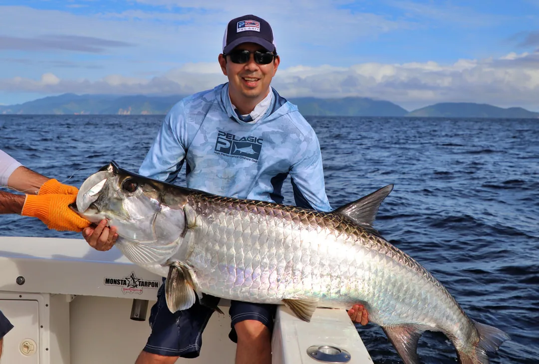A nice Trinidadian Tarpon with the coastline of my former home Venezuela in the background