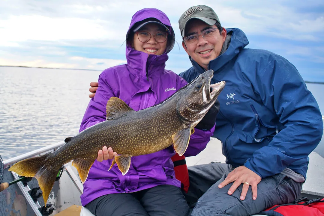 The author's daughter with a colorful Lake Trout caught jigging in Canada