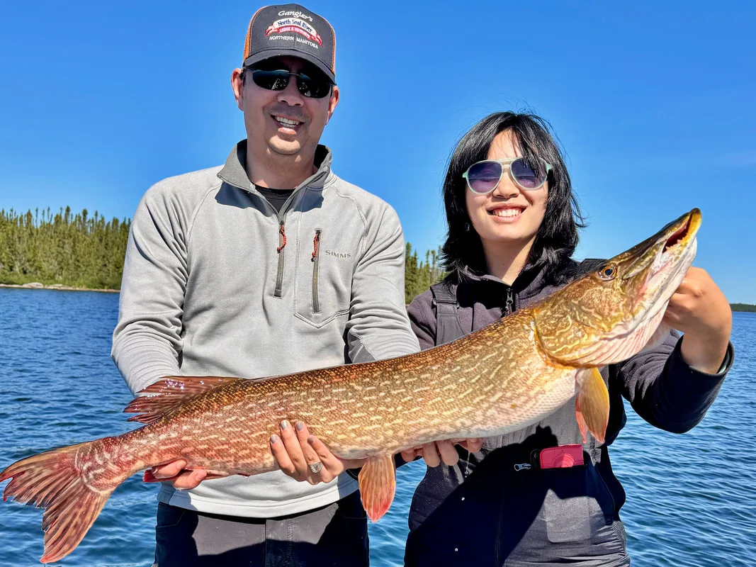 The author and his daughter with a big Pike caught in Booth Lake, Canada on a spoon